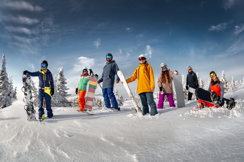 Skiiers and snowboarders standing at the top of a run at a Montana ski resort