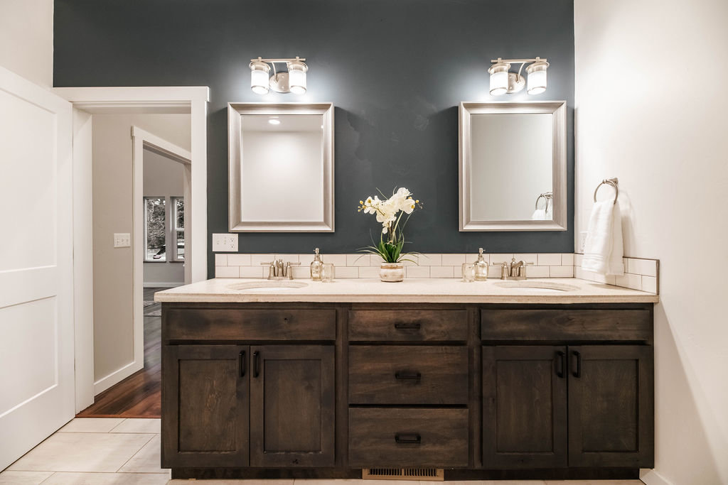 Contemporary bathroom with double sinks and gray accent wall